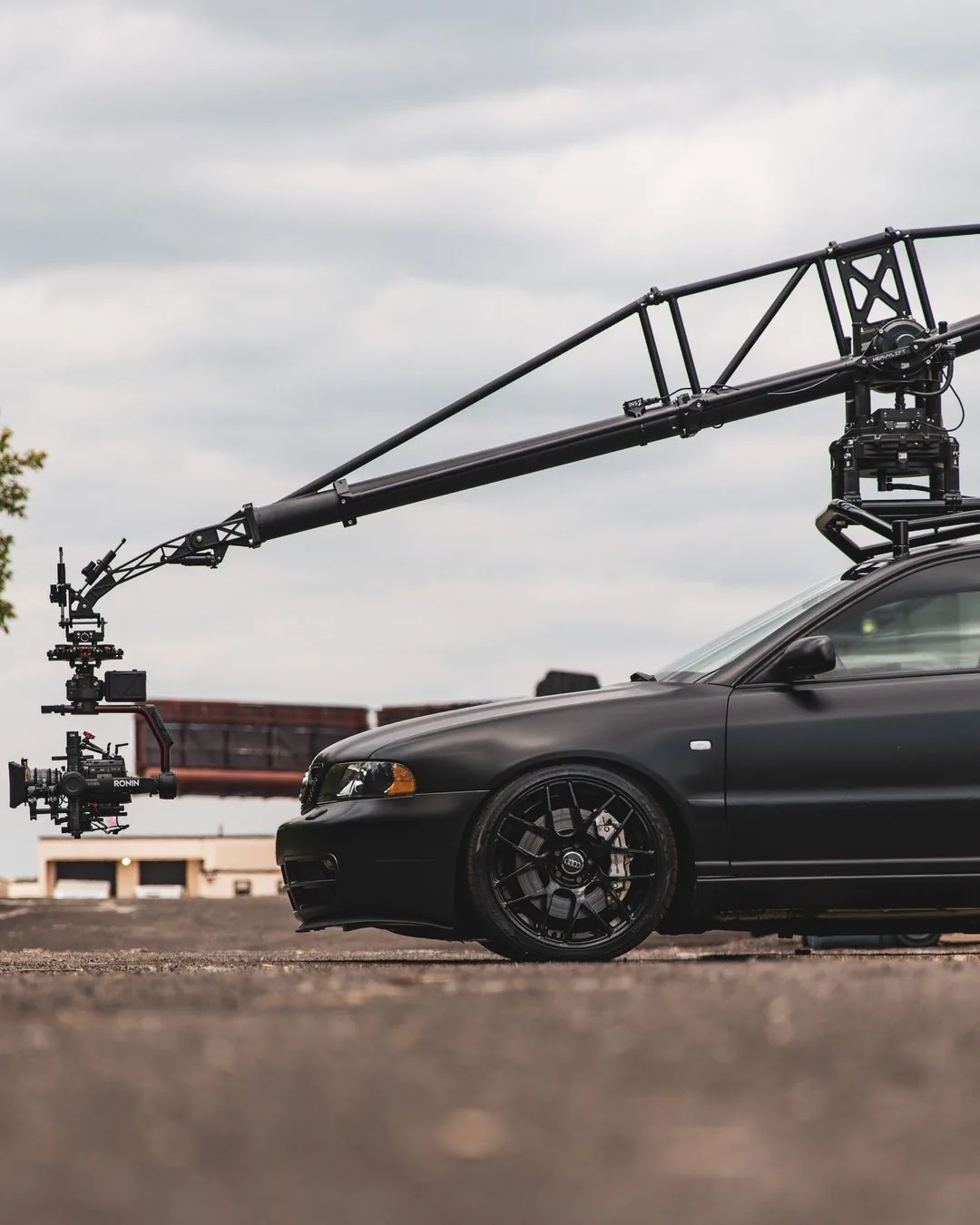MotoCrane camera rig on a matte black Audi S4