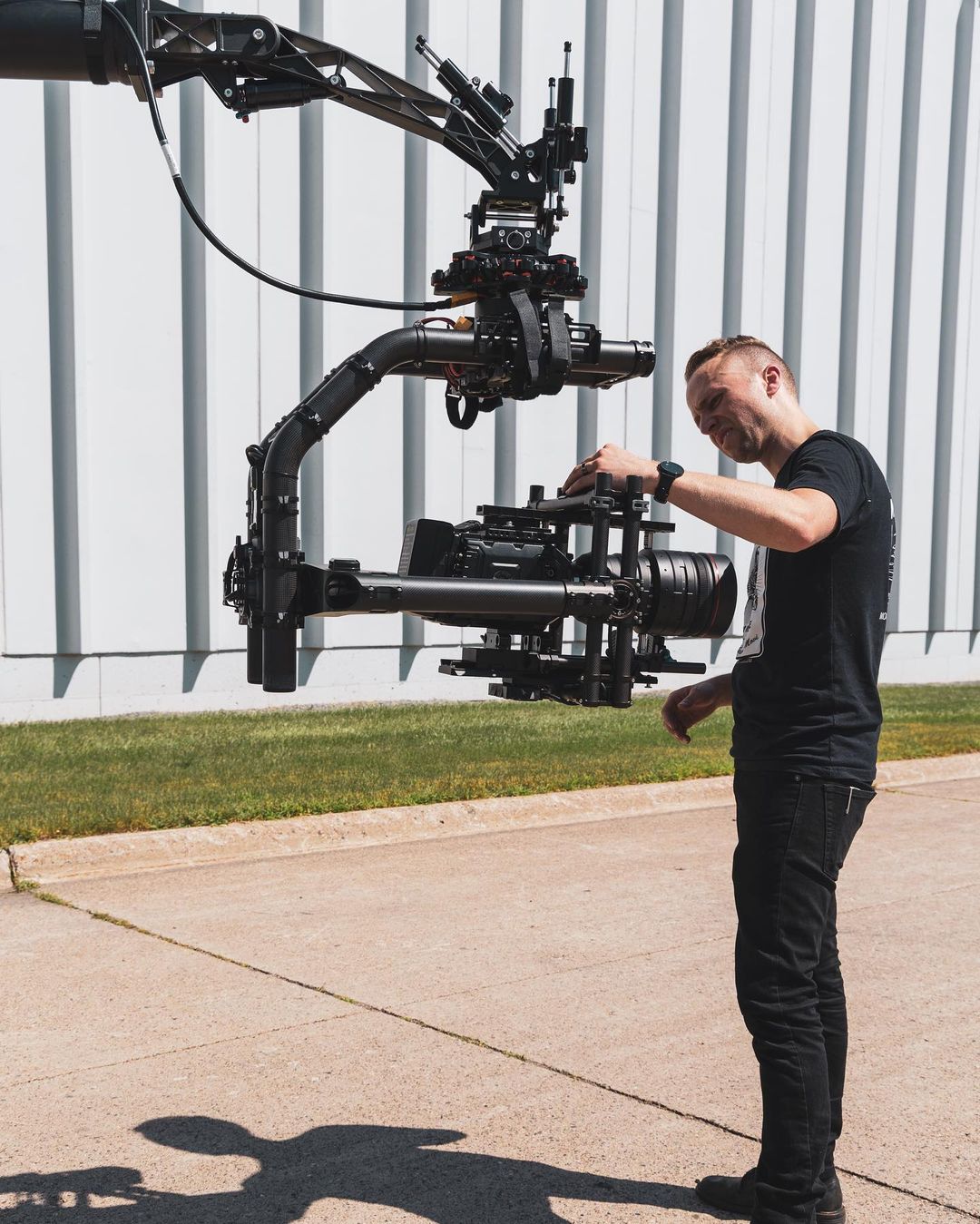 Operator setting up a gimbal-mounted cinema camera